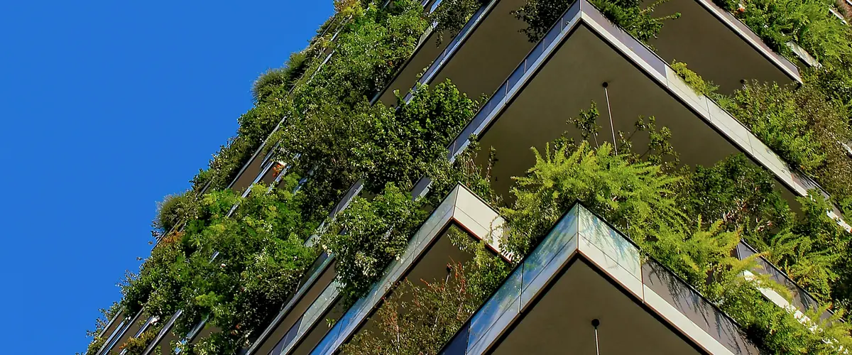ESRS-40a scope — a living green facade on a corporate building, the EUR 450m group limb and the EUR 200m EU foothold