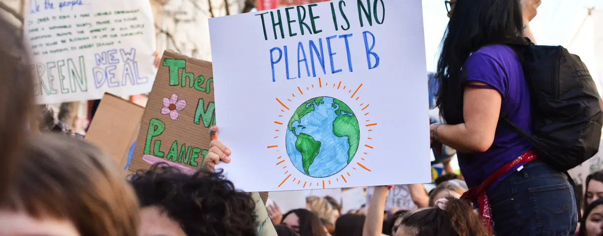 GHG reporting software next steps — climate demonstrators with a There Is No Planet B placard